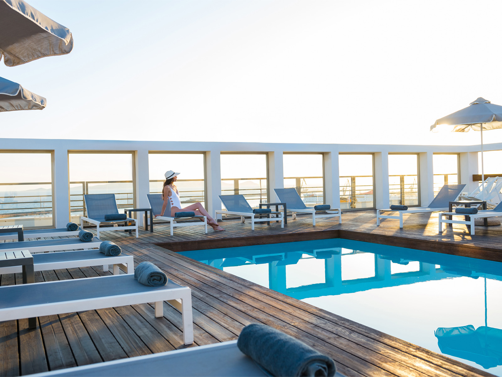 Relaxing poolside with sun loungers, hotel in Crete
